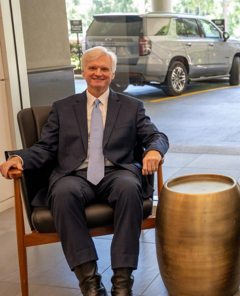 Houston personal injury attorney Drew Shirley seated in the lobby of his Woodway Drive office