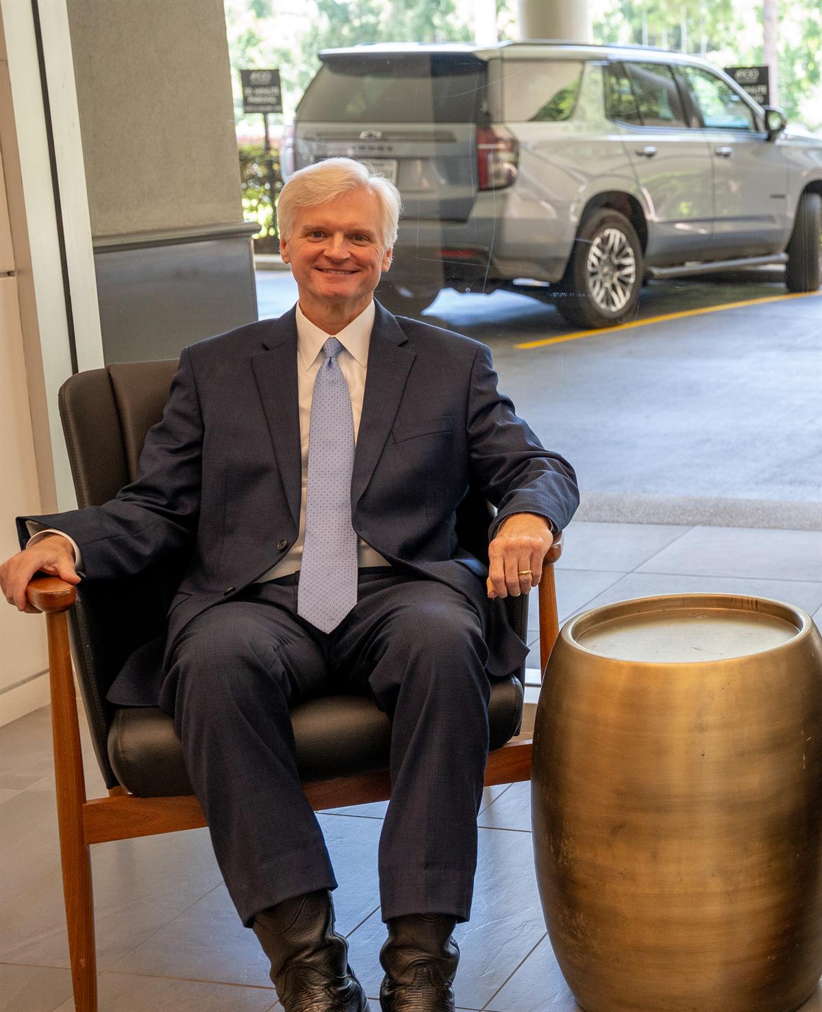 Houston personal injury attorney Drew Shirley seated in the lobby of his Woodway Drive office