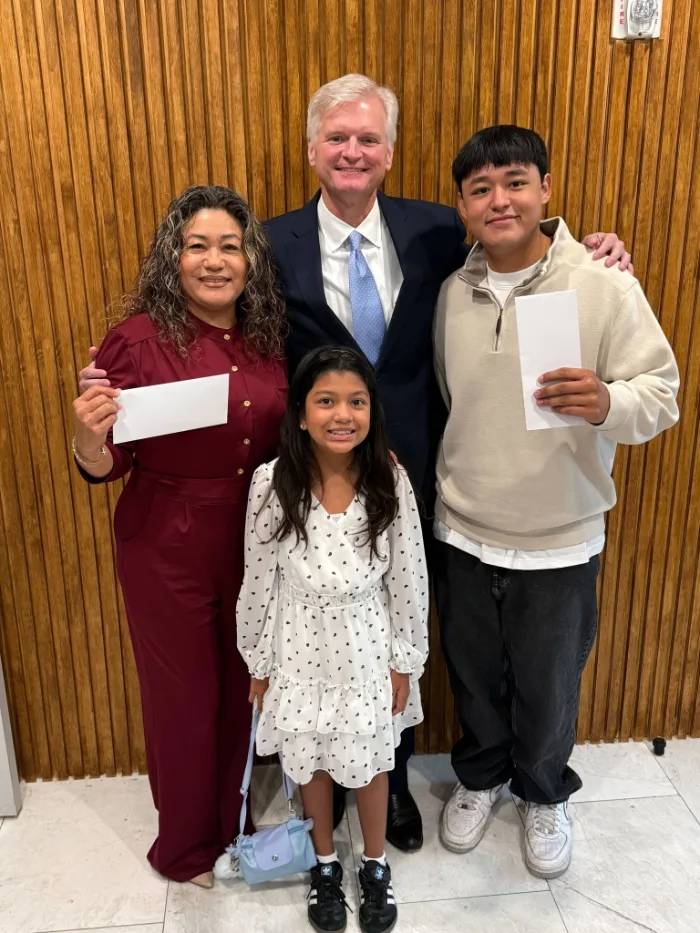 Houston attorney Drew Shirley standing with a mother and her two children after their injury case concluded